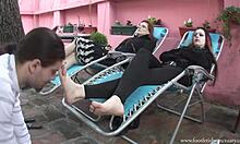 Two babes chilling in recliners and get their feet licked