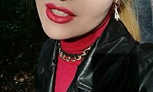 Een mooie blonde wordt in het openbaar geportretteerd en rode lippenstift gebruikt